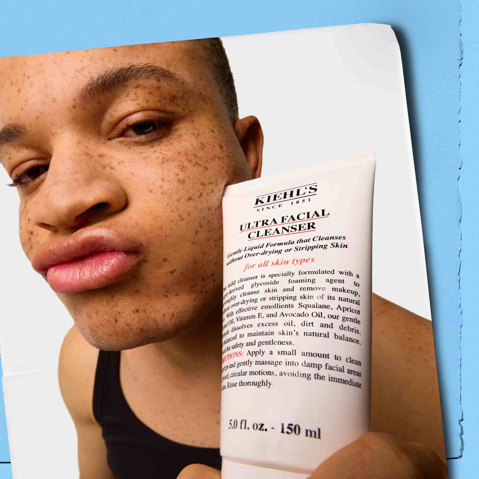 Modelo sosteniendo un tubo de Kiehl's Ultra Facial Cleanser