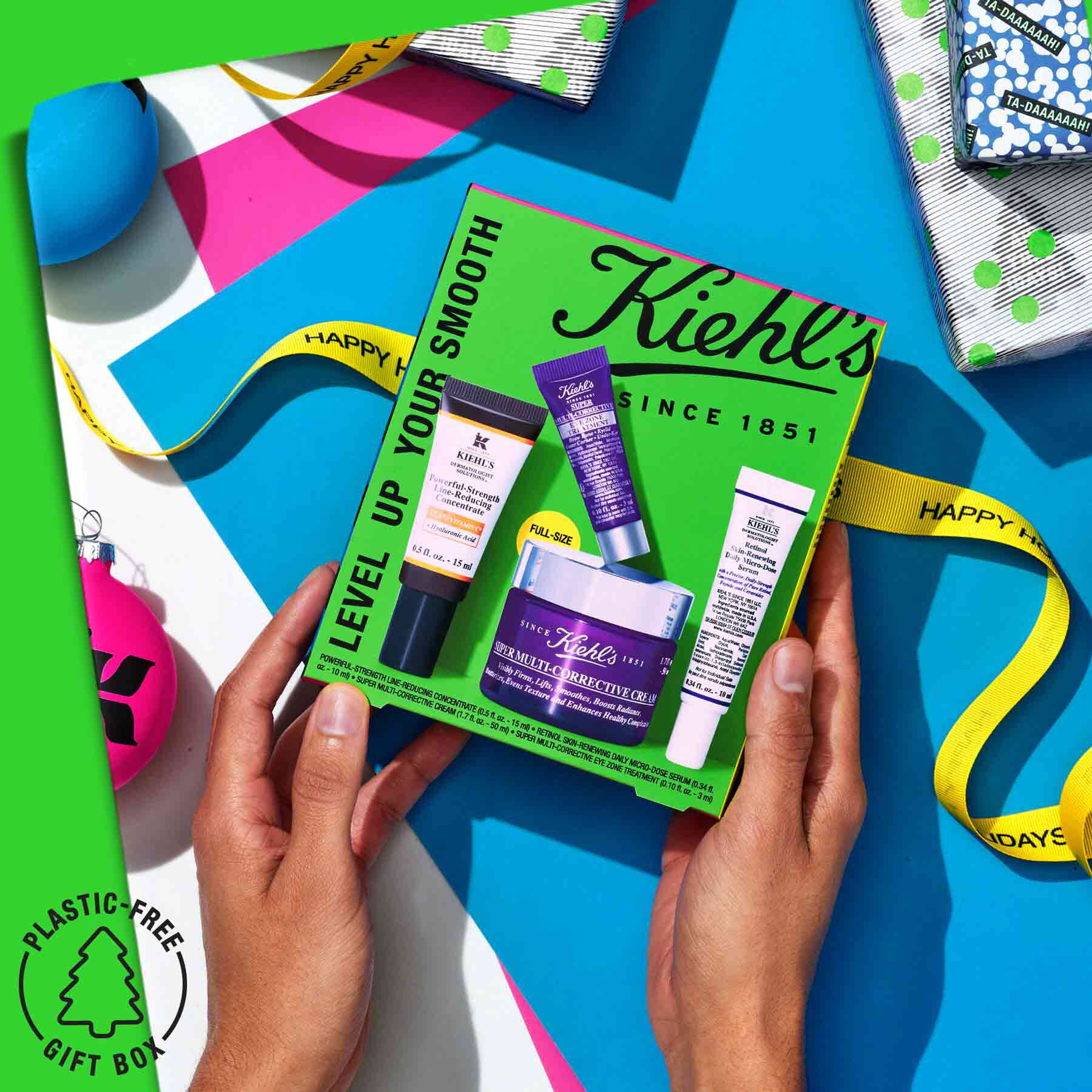 Hands holding a Level Up Your Smooth gift set with a festive background