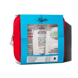 Kiehl's travel-sized skincare gift set in a red pouch, featuring multiple products visible through a blue-themed window.