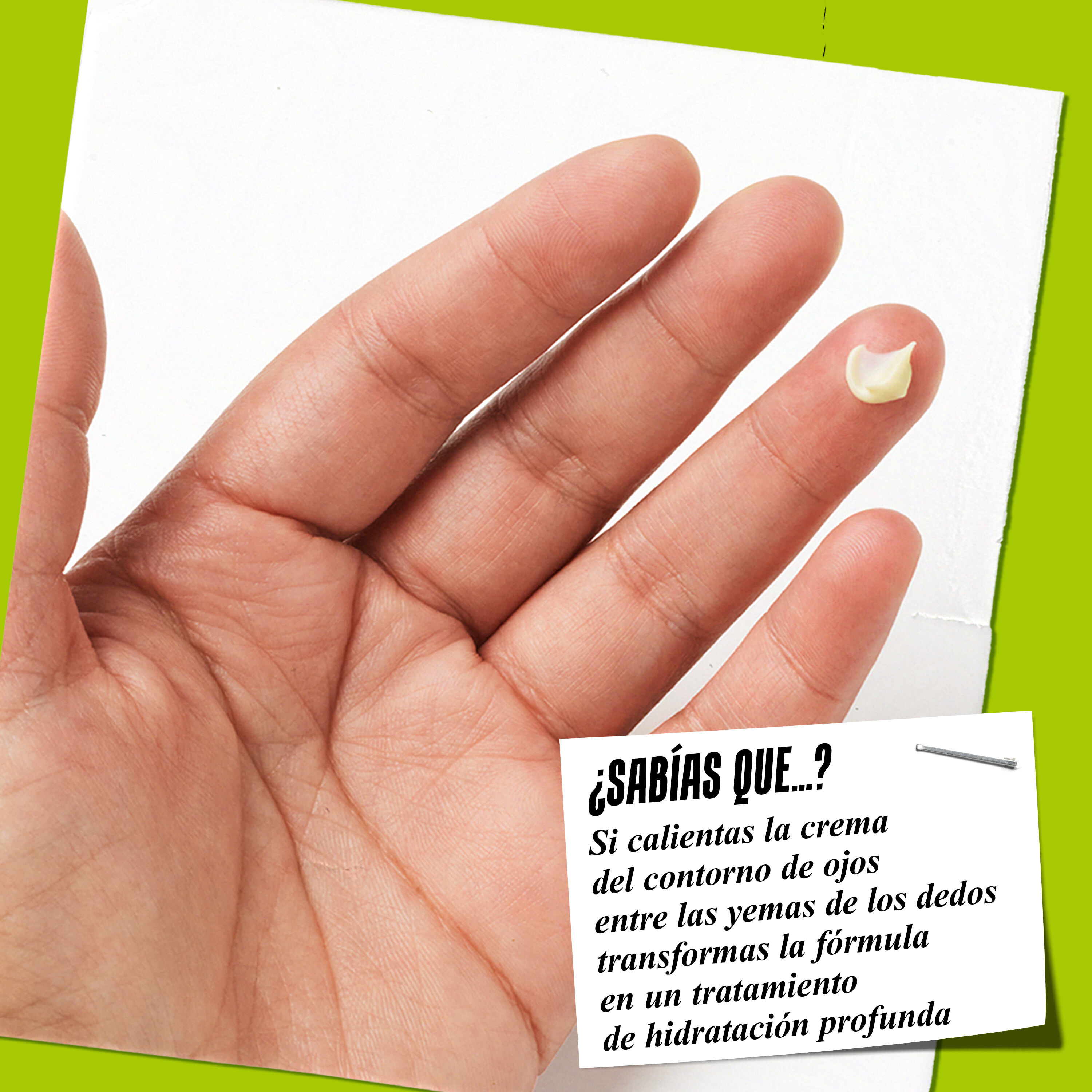 A finger holding a dab of Creamy Avocado Eye Treatment with a tip about warming the formula for better application.