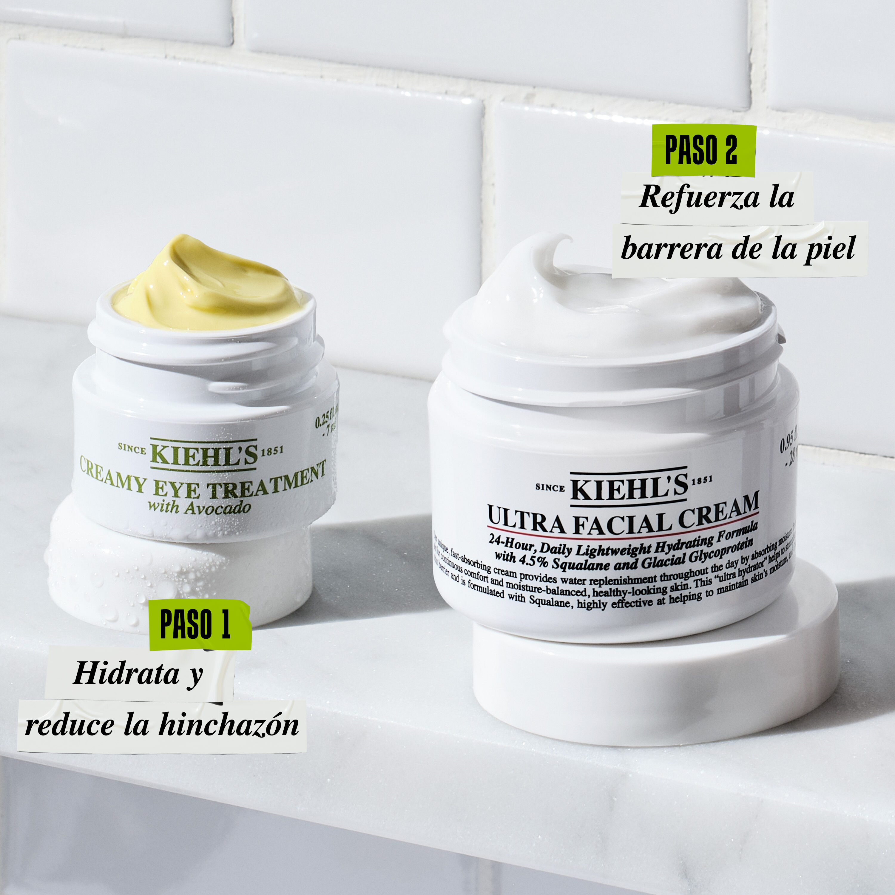 Kiehl’s Creamy Avocado Eye Treatment and Ultra Facial Cream jars labeled as Step 1 and Step 2 in a skincare routine, displayed on a bathroom counter.