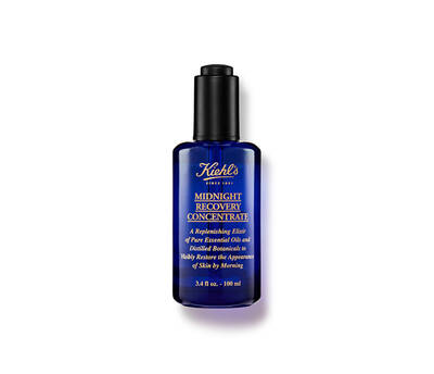 Botella de aceite facial Kiehl’s Midnight Recovery Concentrate, de color azul oscuro, con textura suave y aplicador.