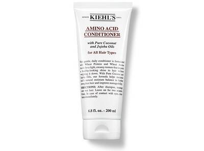 A Kiehl's Amino Acid Conditioner tube, featuring coconut and jojoba oils, suitable for all hair types.