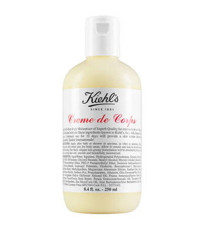 Botella de crema hidratante 'Creme de Corps' de Kiehl's, con etiquetas en blanco y negro, 250 ml. Ideal para piel seca.