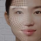 A close-up of a face with a digital grid overlay, highlighting the facial features and contours.