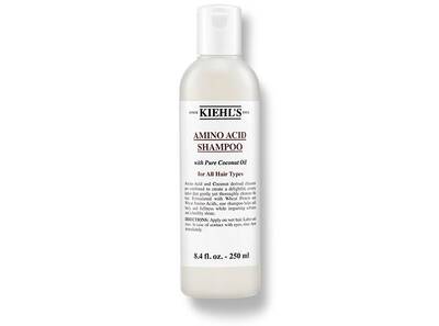 A bottle of Kiehl's Amino Acid Shampoo, 8.4 fl. oz., designed for all hair types, featuring coconut oil.