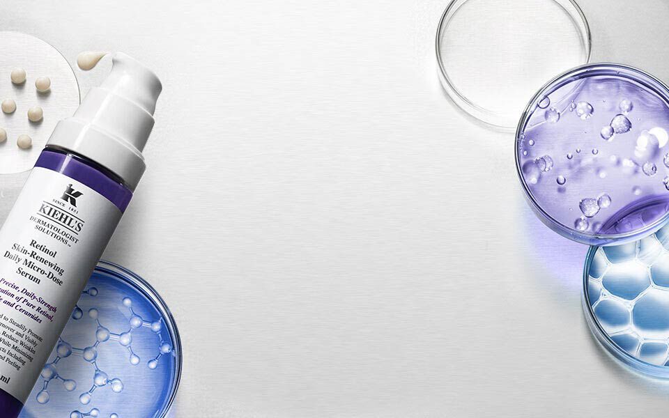 Imagen que muestra frascos y recipientes de laboratorio que contienen productos cosmeticos, junto a un fondo plateado.