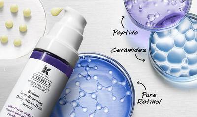 Frasco de suero de retinol de Kiehl's con burbujas de ceramidas y peptidos en un fondo suave y texturizado.
