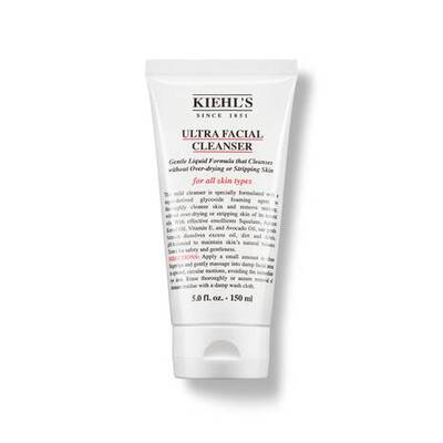Botella de aceite facial Kiehl’s Midnight Recovery Concentrate, de color azul oscuro, con textura suave y aplicador.