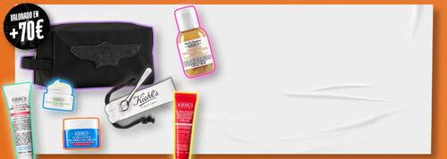 Neceser negro Kiehl's y miniaturas de cuidado facial junto al texto «Valorado en +70€» sobre fondo blanco y naranja.